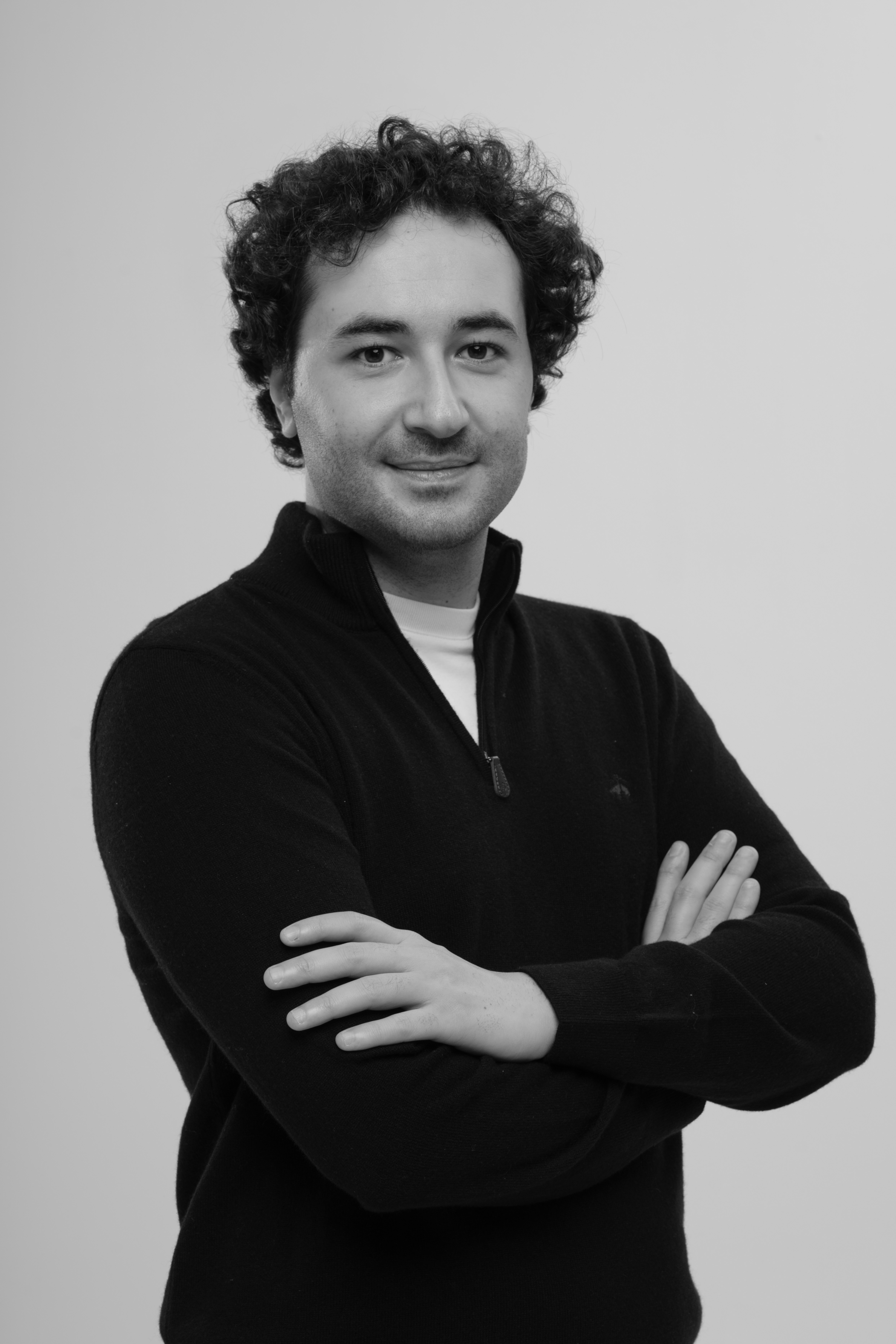 Emre Aydın, founder and director of AVERNOX, photographed in a studio with arms crossed